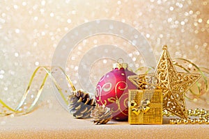 Christmas decorations in red and gold over glitter background