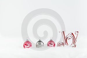 Christmas decorations in red and grey on white fur