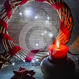 Christmas decorations with ribbons, little lights and candle