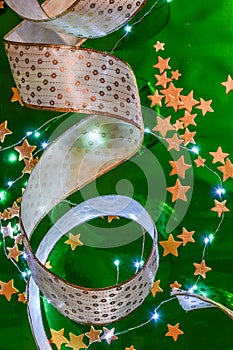 Christmas decorations with ribbons, little lights and golden stars