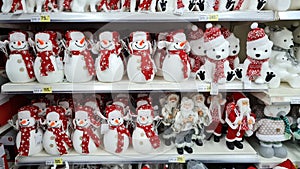 Christmas decorations, Santa Claus, snowman, bears, sells on a shop counter. Festive shopping in mall