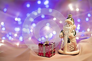 Christmas decorations with Santa Claus toy and present box.