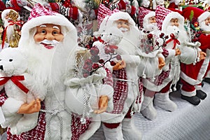 Christmas decorations. Santa Claus toy in supermarket. Santa`s Christmas toys, gifts and souvenirs to decorate the Christmas tree