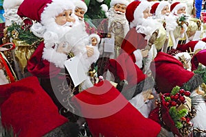 Christmas decorations. Santa Claus toy in supermarket. Santa`s Christmas toys, gifts and souvenirs to decorate the Christmas tree