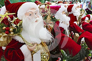 Christmas decorations. Santa Claus toy in supermarket. Santa`s Christmas toys, gifts and souvenirs to decorate the Christmas tree