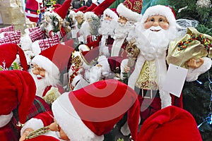 Christmas decorations. Santa Claus toy in supermarket. Santa`s Christmas toys, gifts and souvenirs to decorate the Christmas tree