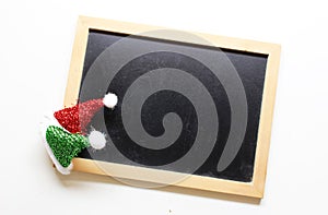 Christmas decorations santa hat on wooden blackboard background
