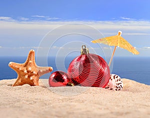 Christmas decorations seashells and starfish on a beach sand