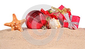 Christmas decorations seashells and starfish on a beach sand on