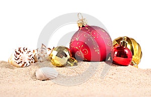 Christmas decorations seashells and starfish on a beach sand