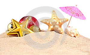 Christmas decorations seashells and starfish on a beach sand on