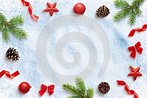 Christmas decorations on snow. Composition with free space in the middle for greeting text