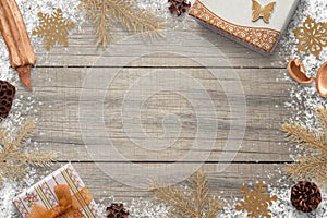 Christmas decorations with snow on wooden board with free space for greeting text