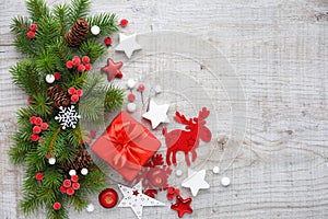 Christmas decorations and spruce branches on a wooden background. Top view, copy space. Christmas or New Year greeting card