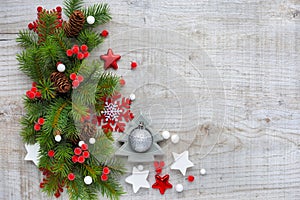 Christmas decorations and spruce branches on a wooden background. Top view, copy space. Christmas or New Year greeting card