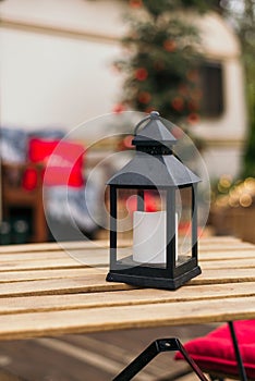 Christmas decorations. Street lamp with candle on the table. outdoor. Decoration Xmas and holiday