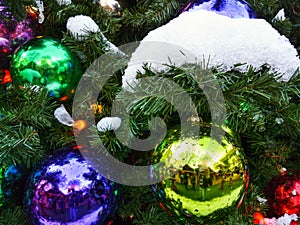 Christmas decorations on a tree covered with snow