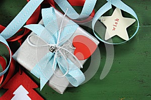 Christmas decorations on vintage green wood background, with silver gift closeup.