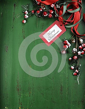 Christmas decorations on vintage green wood background. Vertical with Merry Christmas tag.