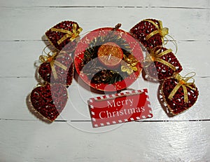 Christmas decorations on white board. Christmas concept, decorated Christmas candle and glittery Christmas ornaments