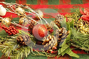 CHRISTMAS decorations, white branches, pine cones, red berries, evergreen branches