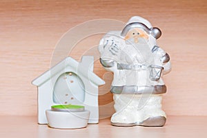 Christmas decorations, white ceramic figurine of santa claus and candle holder with tea candle