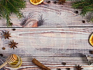 Christmas decorations on wooden background, orange, cinnamon, stars, fir branches. Copy space.