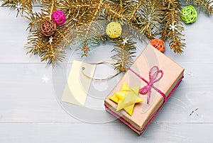 Christmas decorations wooden background top view. Present box and gift tag copy space. Winter time and christmas