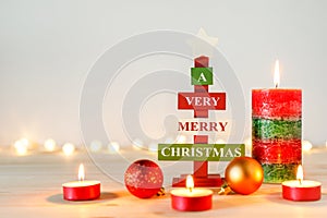 Christmas decorations on wooden table with defocused holiday lights in background. Copy space