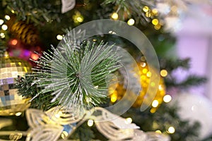 Christmas decorations on xmas tree with hanging balls and ornaments and bokeh background