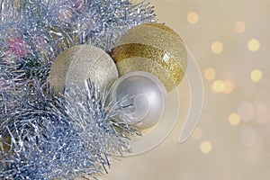 Christmas decorations. Yellow and white Christmas balls and silver tinsel