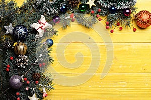 Christmas decorations on yellow wooden texture background