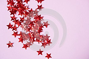 Christmas decorative red stars on dusty pink color background