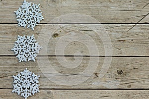 Christmas decorative silvery snowfields on a rustic wooden background.