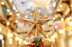 A Christmas decorative - star on the top of A Christmas tree with a beautiful bokeh background