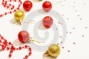 Christmas decorative toys in red and gold color with red beads for decor and stars on a white background