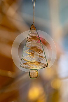 A Christmas decration hanging in atmospheric light, with a shallow depth of field