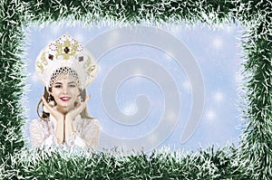 Christmas design-Christmas card with a beautiful, young, smiling woman dressed as Santa Claus, bordered by pine needles with a