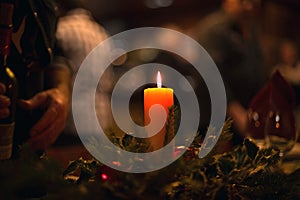 Christmas dinner with a burning candle in the middle and bokeh.