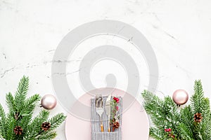 Christmas dinner decoration with gift box, plate and fir tree white table background top view mock-up