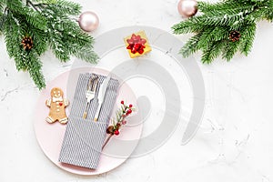 Christmas dinner decoration with gift box, plate and fir tree white table background top view mock-up