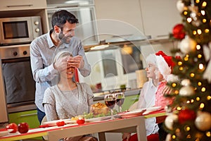 Christmas dinner- happy father and children surprises mother photo