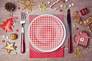 Christmas dinner plate setting with rustic decorations. View from above