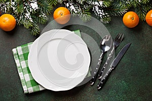 Christmas dinner plate, silverware, fir tree, oranges