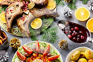 Christmas dinner with roasted meat steak, Christmas Wreath salad, baked potato, grilled vegetables, cranberry sauce