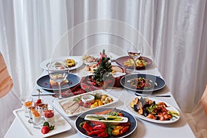 Christmas Dinner. A table in the restaurant, served for two people, is ready for the New Year