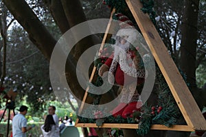 Christmas dolls ganging from trees photo