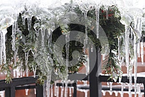 Christmas door decoration covered in ice and icecles outdoor in the winter.