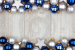 Christmas double border of blue and silver ornaments on gray wood