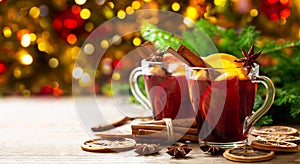 Christmas drink. Glasses of hot mulled wine with oranges, anise and cinnamon photo